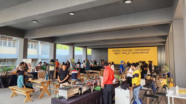 Activity Hall at Science Gallery Bengaluru, vibrant outdoor event with food vendors and activities.