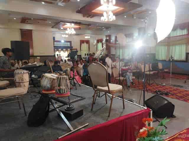 Prakruti Paradise Banquet Hall stage set for live performance event with inviting lighting.
