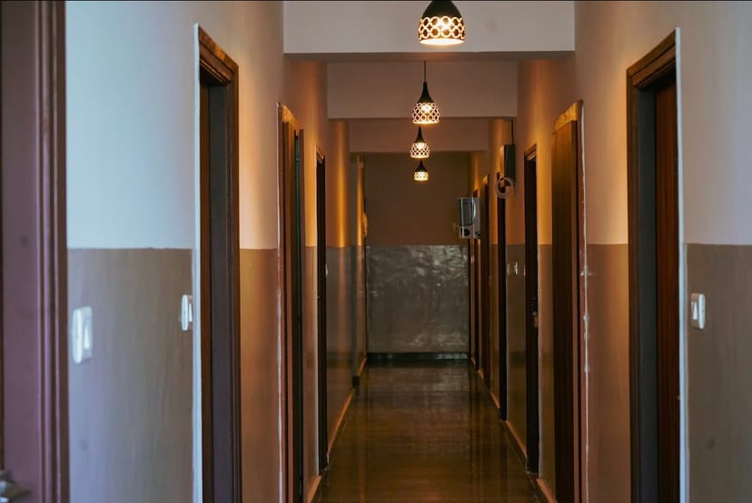 Contemporary hotel corridor with pendant lights, ideal for networking events and meetings.