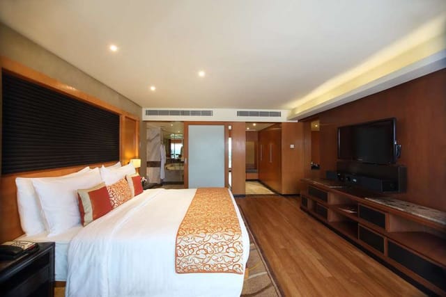 Elegant hotel room with flat-screen TV, ideal for conferences and events in Gokulam Grand.