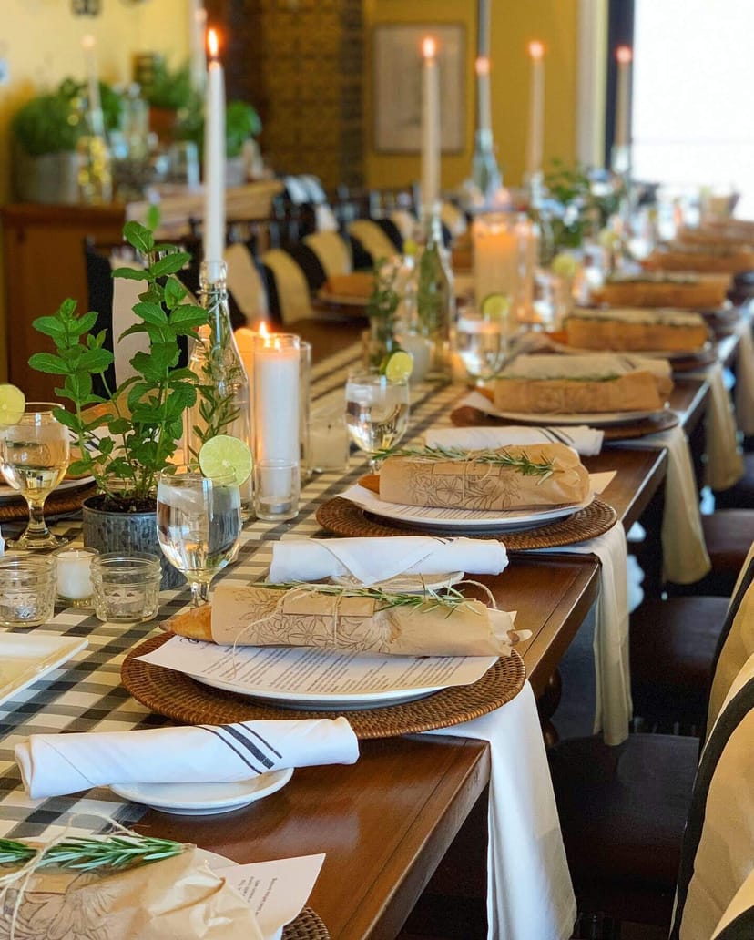 Elegant long dining table with rosemary garnishes for Arcadia Farms Café event.