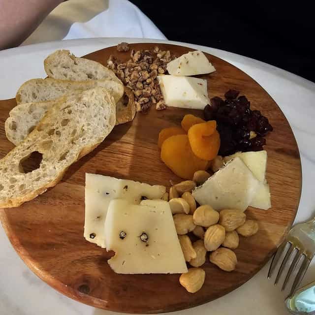 Elegant charcuterie platter with cheeses and fruits at La Mariposa, perfect for events.