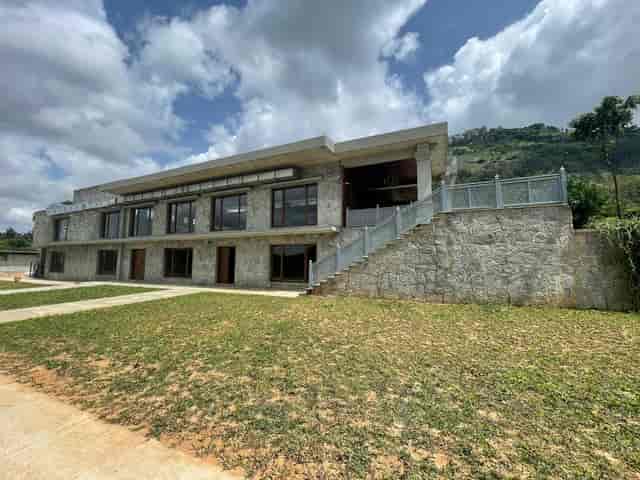 Modern event venue with large windows and staircase for corporate meetings and gatherings.