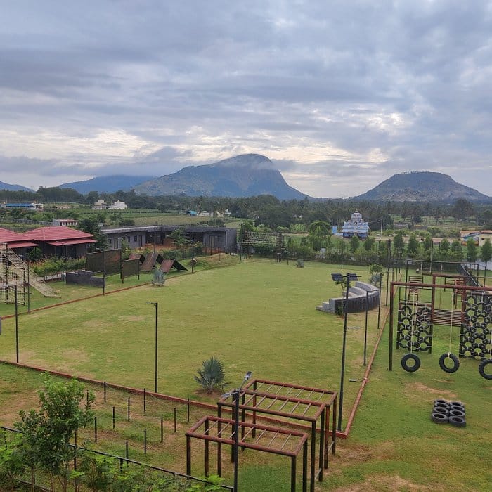 Spacious outdoor venue at VAMA Retreats with scenic mountains, perfect for corporate events.