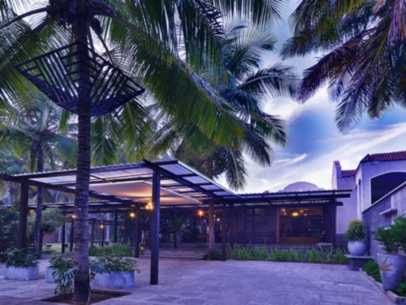Outdoor event venue at Windflower Resort, framed by palm trees, ideal for weddings and retreats.