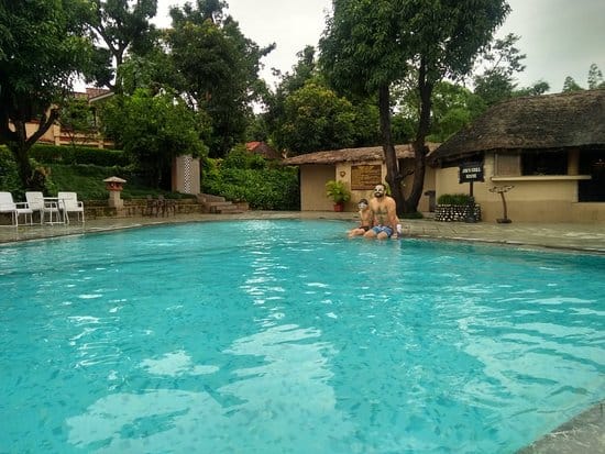 Lawn by pool at The Riverview Retreat, ideal for networking and relaxation events.