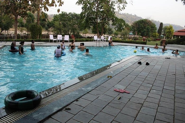 Lawn by swimming pool at The Riverview Retreat, ideal for networking and team-building events.