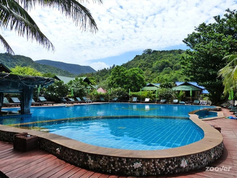 Serene poolside hotel resort in greenery, perfect for outdoor events and gatherings.