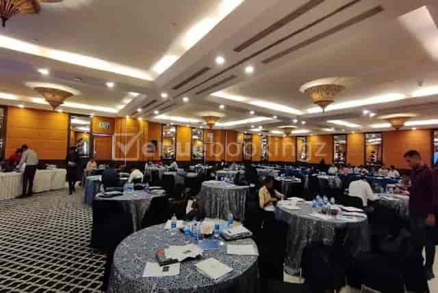 Ballroom 3 at Fortune Hotels set for a conference with round tables in silver linens.