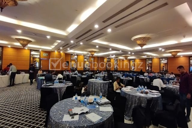 Ballroom 3 at Fortune Hotels set for a conference with round tables in silver linens.