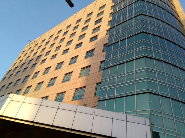 Grand Ballroom at Fortune Hotels: modern venue with large windows for corporate events.