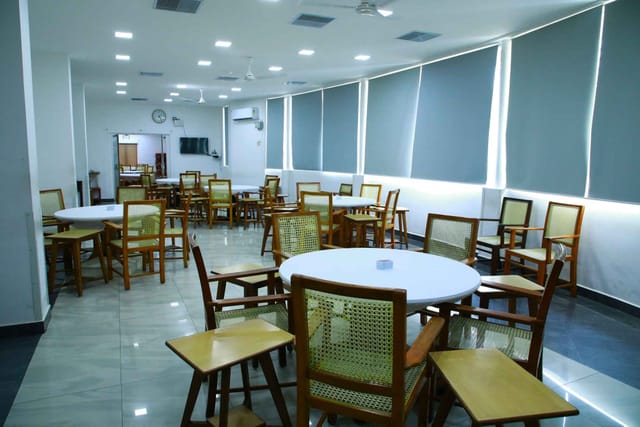 Alt text: Cards Section in Cospolitan Club with round tables, ideal for workshops and networking.
