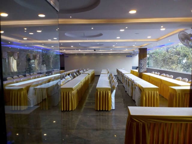 Conference Hall in Cospolitan Club with yellow tablecloths, ideal for seminars and workshops.