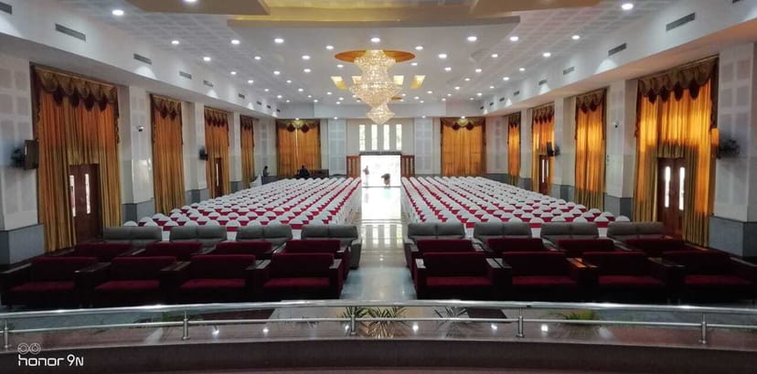 Elegant conference hall with seating for events, ideal for ceremonies and presentations.