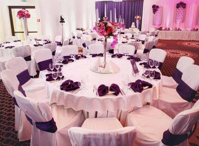 Elegant banquet hall with white table linens, perfect for weddings and corporate events.
