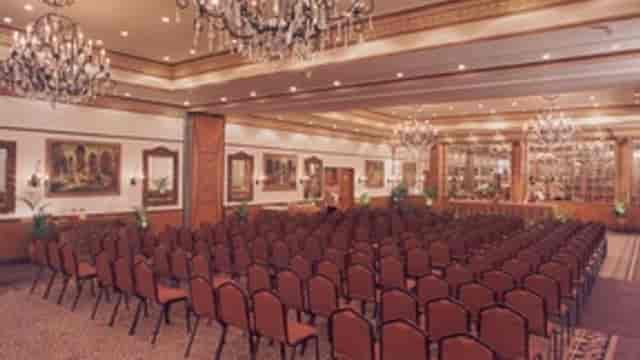 Conference venue with elegant chandeliers at Golden Palms Hotel & Spa.