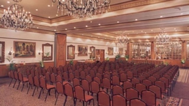 Conference venue with elegant chandeliers at Golden Palms Hotel & Spa.