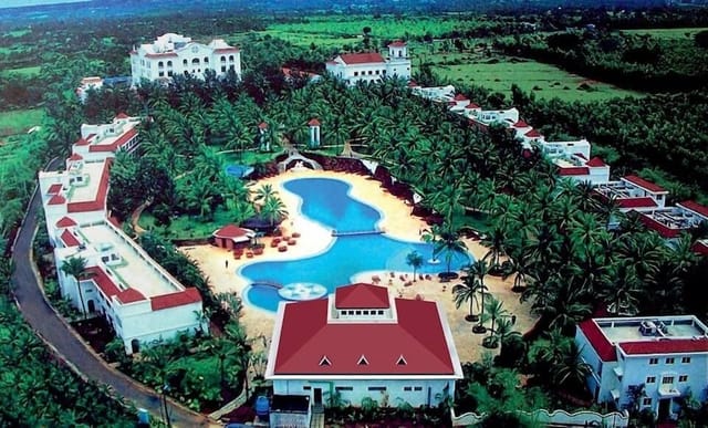 Conference at Golden Palms Hotel & Spa with serene pool and lush greenery for corporate events.
