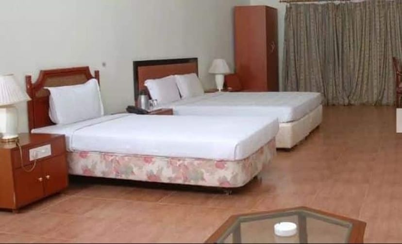 Conference Hall at Hill View Resorts with twin beds for meetings and events.