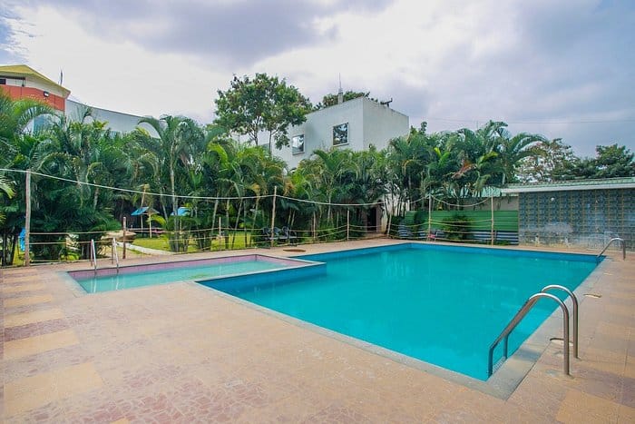 Lawn at Green Leaf Resort with pristine pool, ideal for outdoor events and relaxation.