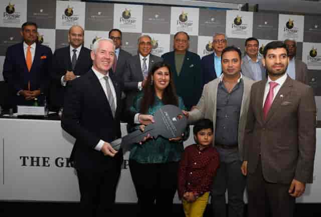Meeting Room at JW Marriott Bengaluru with executives at a press conference and ceremonial key.