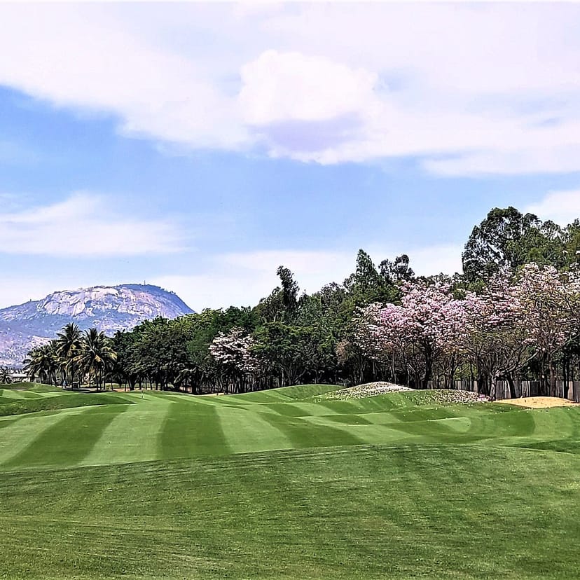 Bangalore Golf Club tournament with scenic mountains and trees, ideal for corporate retreats.