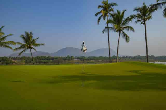 Bangalore Golf Club tournament with lush greens, palm trees; ideal for corporate retreats.