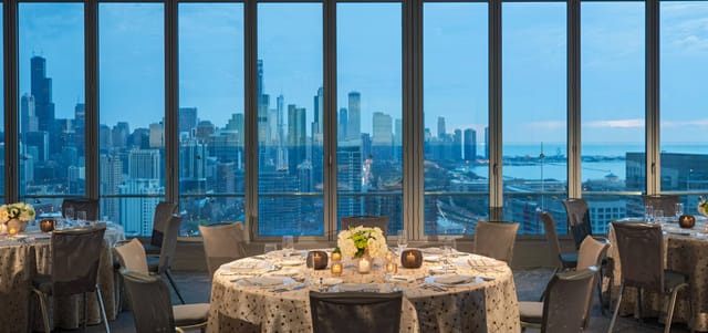 Elegant dining table with skyline view at Great Lakes Ballroom, perfect for upscale events.