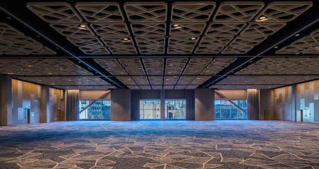 Grand Horizon Ballroom, modern venue with patterned ceiling, ideal for conferences and corporate events.