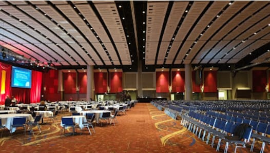 McCormick Place West Building event hall set up for a large conference with stage.