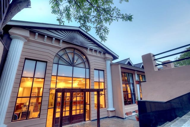 Elegant resort hotel in Chinar Pahalgam with large windows, perfect for events.