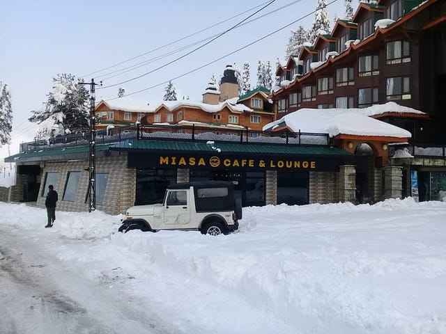 Snow-covered Mizaas Cafe & Lounge at Fine Dine Restaurant, ideal for winter corporate retreats.