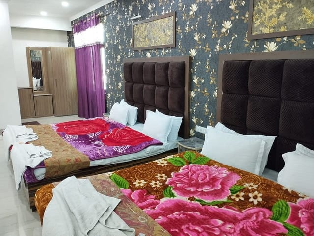 Classic Suite at Triden Kashmir Resort with two beds, perfect for event relaxation.