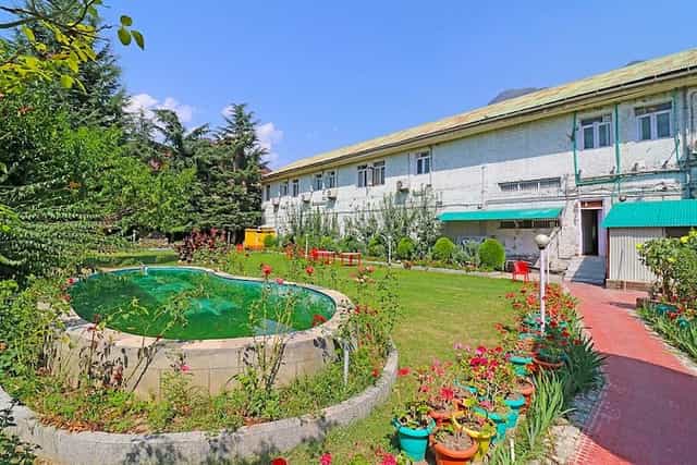 Outdoor venue at Hotel Paradise Gateway with lush greenery, perfect for events.