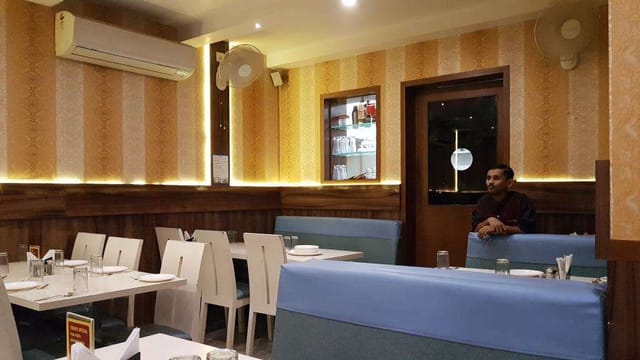 Cozy Waves Restaurant interior with light blue accents, perfect for casual gatherings.