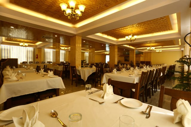 Elegant dining area at The Grand Mamta, ideal for events and corporate functions.