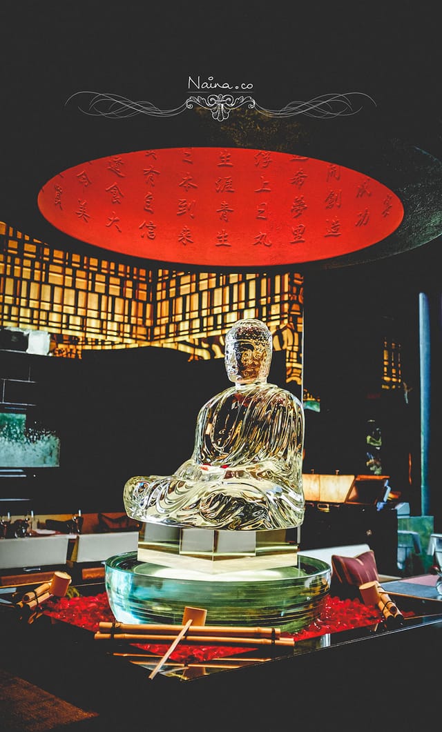 "Glass Buddha sculpture in The Leela, perfect for meditation and wellness retreats."