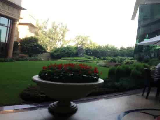 Terrace courtyard at The Leela, vibrant flowers, ideal for events and receptions.