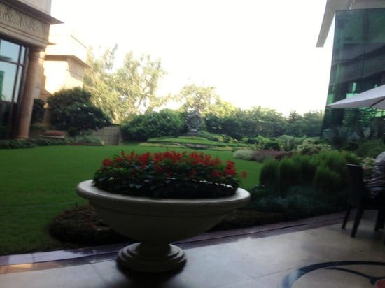 Terrace courtyard at The Leela, vibrant flowers, ideal for events and receptions.