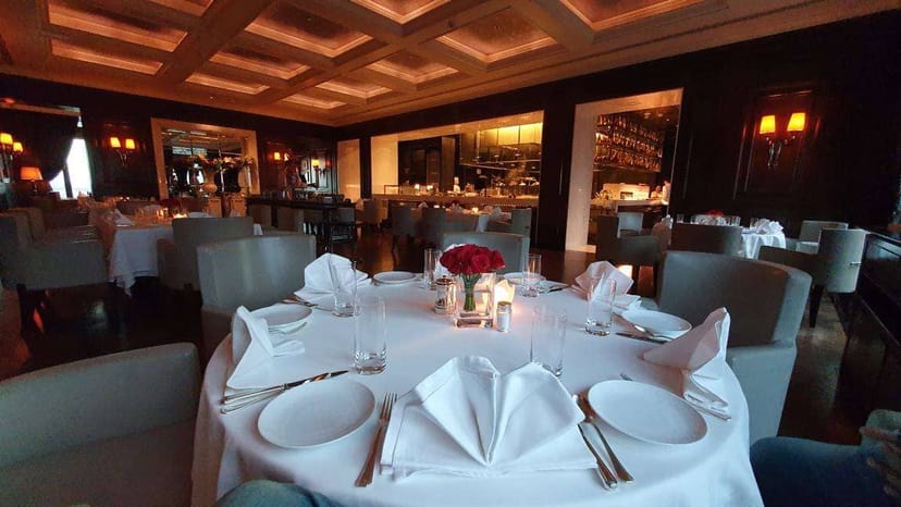 Elegant dining at Le Cirque, round table setting for corporate events and gatherings.