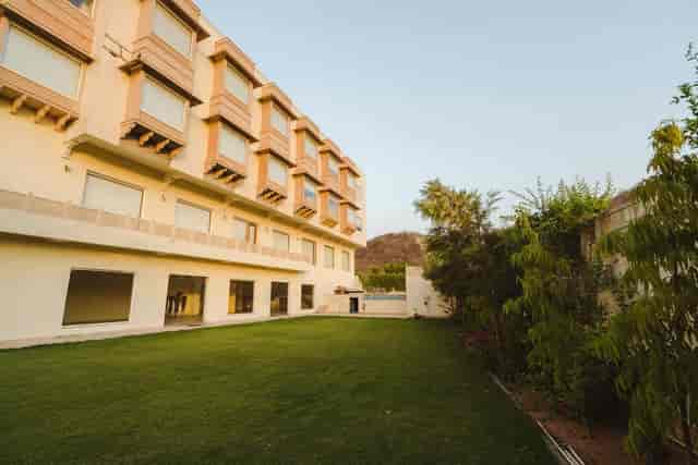 Modern conference hall with spacious lawn for corporate events and social gatherings.