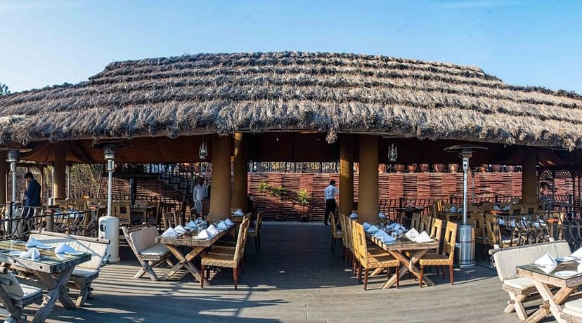 Rooftop dining at The Monal with a thatched roof, perfect for events and gatherings.