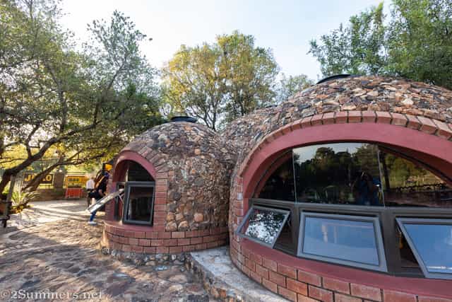 Outdoor meeting venue at Thatch Chapel with rustic dome structures for team-building retreats.