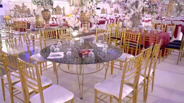 Elegant banquet hall with gold-accented chairs for weddings and corporate events.