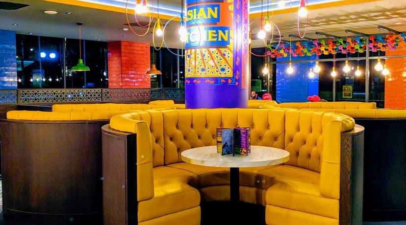 Leeds Events Lounge: cozy yellow booths in vibrant venue for casual gatherings and networking.
