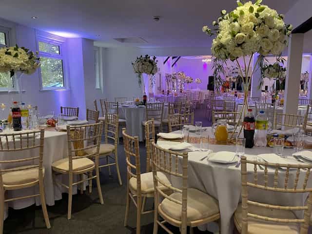 Elegant Roslyn Suite banquet space with floral decor and soft lighting for celebrations.
