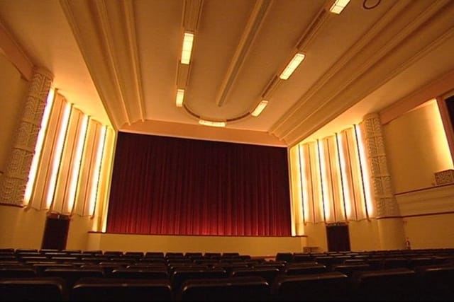 Main Auditorium of The Regal Theatre with red curtain, perfect for presentations and performances.