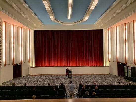 Main Auditorium at Regal Theatre with grand stage and red curtains for events.