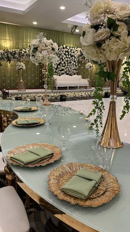 Elegant banquet hall setup with round table, greenery, perfect for upscale events.