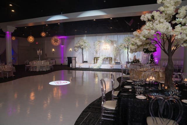Elegant Oasis Ballroom setup for weddings with floral decor and polished dance floor.